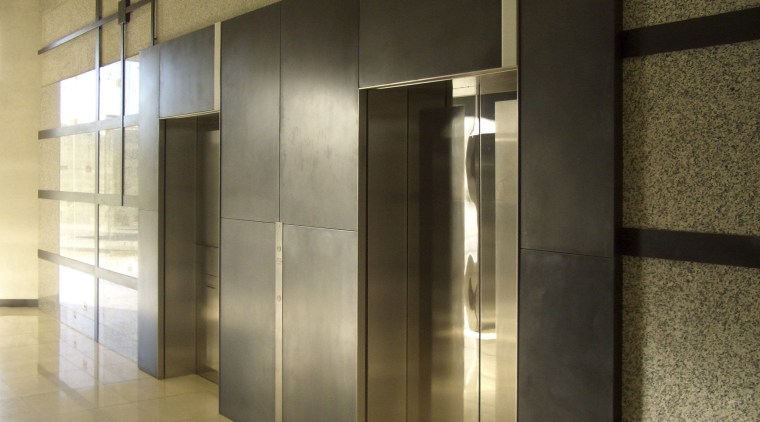 View of brass walls fabricated by Craft Metals door, glass, interior design, lobby, wall, brown