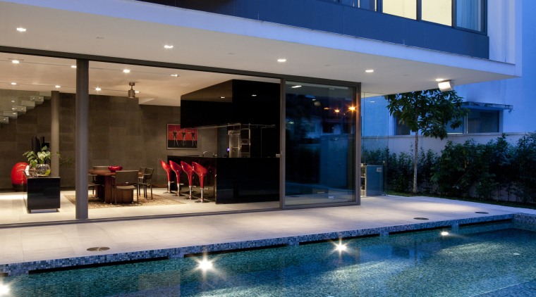 Exterior view of the poolside terrace at the architecture, condominium, estate, home, house, leisure, lighting, property, real estate, reflection, swimming pool, water, blue