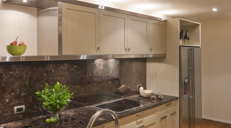 View of a kitchen which features timber floors, cabinetry, ceiling, countertop, floor, interior design, kitchen, under cabinet lighting, brown