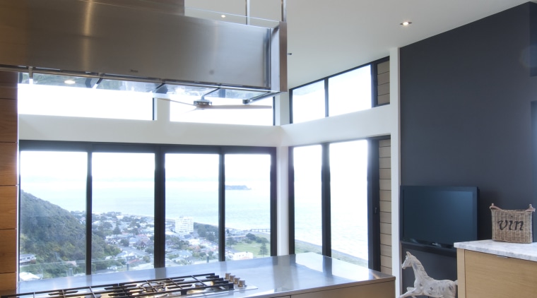 Raised floor kitchen. Stainless steel Binova cooktop. American architecture, daylighting, interior design, kitchen, white, gray