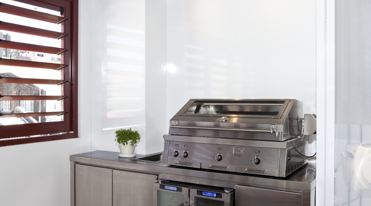 View of an outdoor kitchen which features a home appliance, interior design, kitchen, major appliance, white