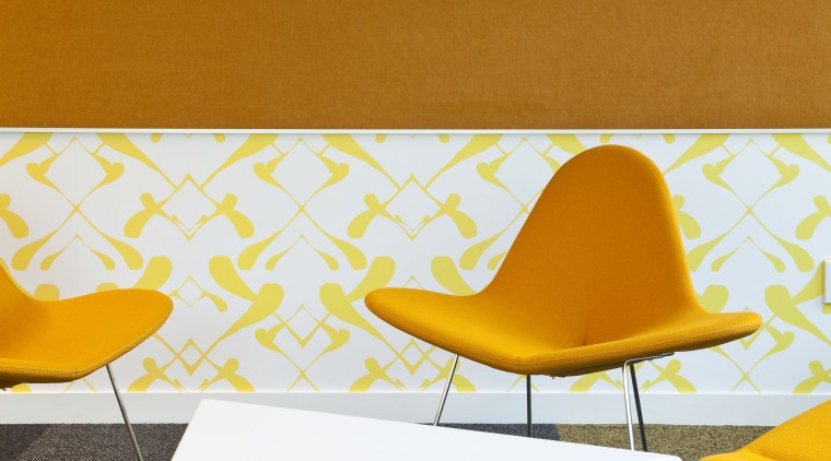 View of furnishings by Fletcher Systems for the angle, chair, design, floor, flooring, furniture, interior design, line, orange, product design, table, wall, wood, yellow, white, orange, brown