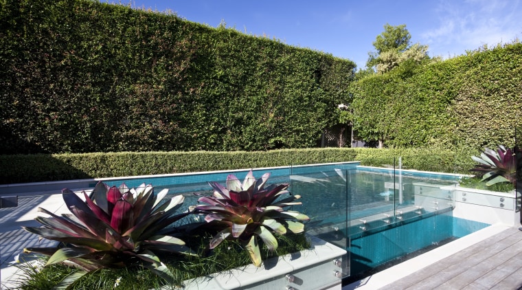 The rear yard of this home has been estate, flower, garden, landscape, landscaping, leisure, nature, plant, property, real estate, resort, sky, swimming pool, tree, villa, water
