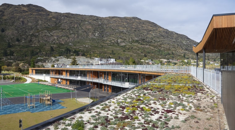 View of green roof at Remarkables Primary School. cloud, house, landscape, leisure, mountain, plant, real estate, reflection, sky, tree, water, teal, gray