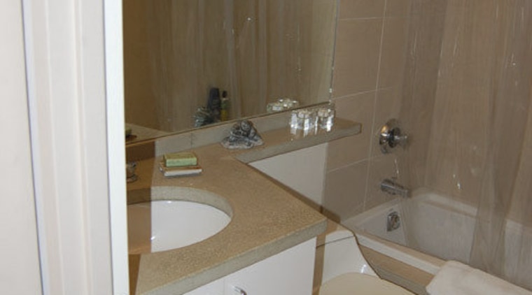 This home was remodeled by Forma Inc. A bathroom, floor, home, interior design, plumbing fixture, property, room, sink, tile, brown, gray