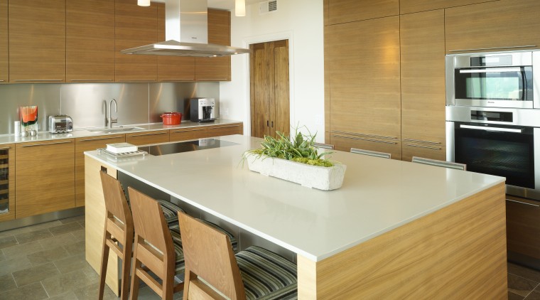 Architectural designer Mark Williams specified sleek Bulthaup walnut cabinetry, countertop, cuisine classique, floor, flooring, hardwood, interior design, kitchen, real estate, room, wood flooring, brown, orange
