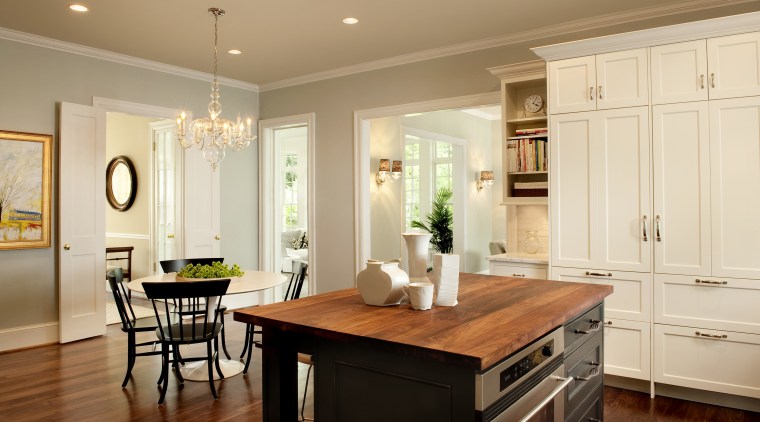 View of kitchen designed by Nadia Subaran. Designed cabinetry, ceiling, countertop, cuisine classique, dining room, floor, flooring, furniture, hardwood, home, interior design, kitchen, room, table, wood flooring, orange