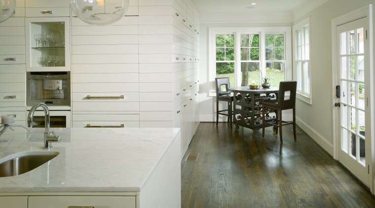 View of kitchen by Designer Willis Watts. Remodelled cabinetry, countertop, cuisine classique, floor, flooring, hardwood, home, interior design, kitchen, laminate flooring, room, tile, wood, wood flooring, gray