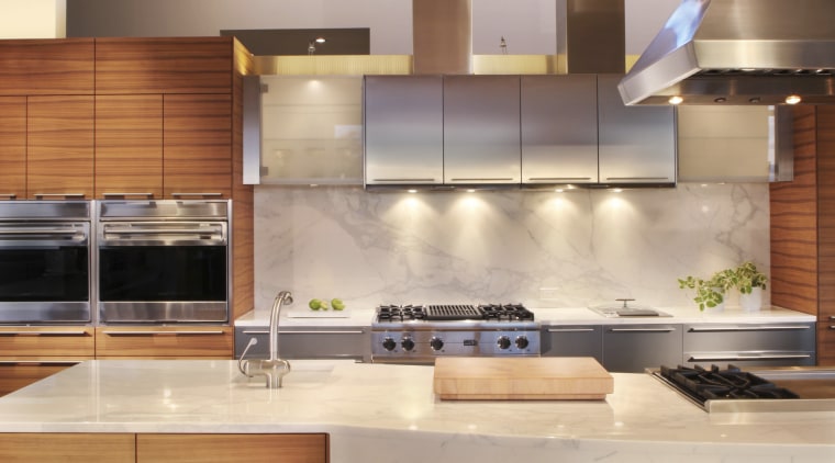 This kitchen was designed and manufactured by Bulthaup. cabinetry, ceiling, countertop, cuisine classique, hardwood, interior design, kitchen, under cabinet lighting, wood, wood flooring, orange, brown