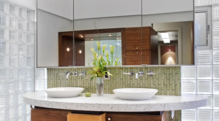 Walnut cabinetry lines the entry to this glass bathroom accessory, cabinetry, countertop, furniture, interior design, kitchen, product design, sink, white