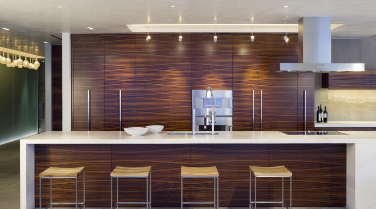 Kitchen area with bar stools. - Kitchen area cabinetry, ceiling, countertop, flooring, furniture, interior design, kitchen, lobby, wall, gray