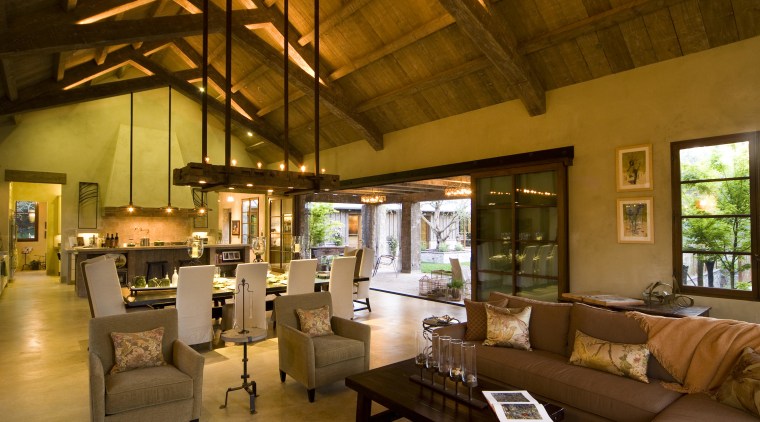 Rustic house modelled on French barn. Interiors feature interior design, living room, lobby, real estate, brown