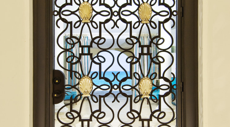 This home was designed by Geoffrey Bradfield. Here glass, iron, stained glass, window, yellow, brown