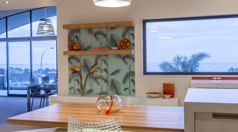 A central island takes pride of place in architecture, ceiling, countertop, home, house, interior design, kitchen, living room, room, table, orange