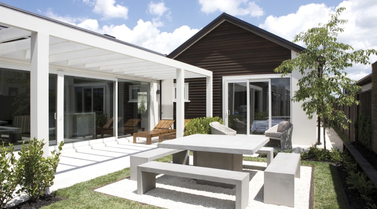 This 'Life at Home' home features paving from backyard, cottage, estate, home, house, property, real estate, residential area, villa, white