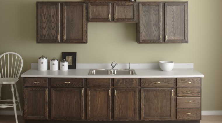 Seen here is a kitchen with a Kohler bathroom, bathroom accessory, bathroom cabinet, cabinetry, chest of drawers, countertop, cuisine classique, furniture, hardwood, kitchen, product design, sink, wood stain, brown