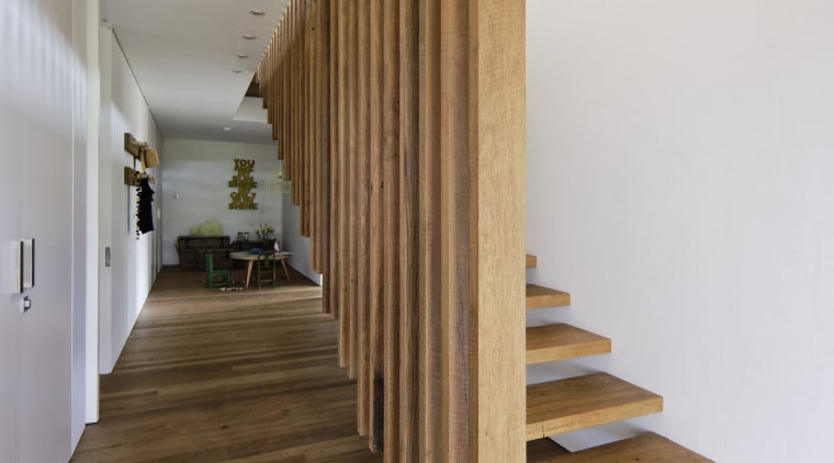 Slats from the kitchen island above extend down architecture, daylighting, floor, flooring, handrail, hardwood, house, interior design, laminate flooring, stairs, wood, wood flooring, brown, gray