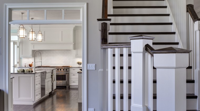 New wide openings were created between the kitchen floor, flooring, furniture, hardwood, home, interior design, stairs, wood, wood flooring, gray