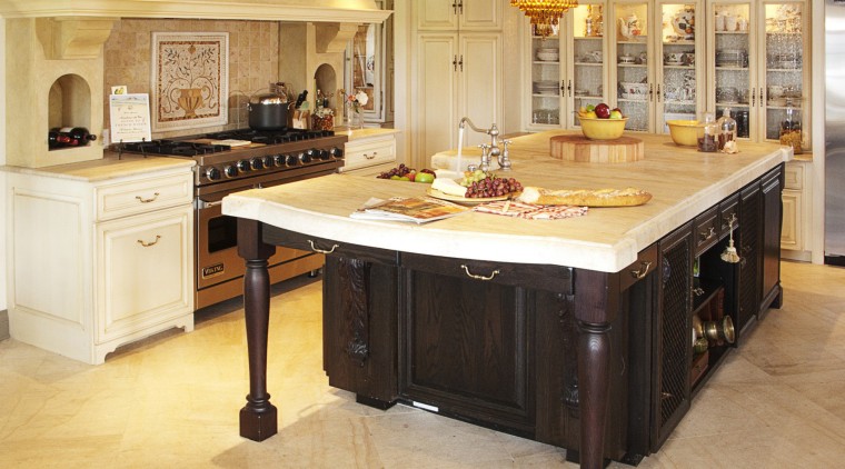 The dark-stained, oak island, which has a distinctive cabinetry, countertop, cuisine classique, floor, flooring, furniture, hardwood, interior design, kitchen, room, table, wood flooring, orange