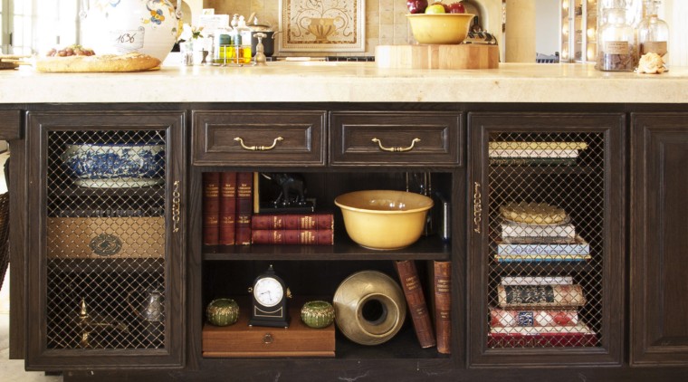 The island in this French kitchen features decorative cabinetry, furniture, black