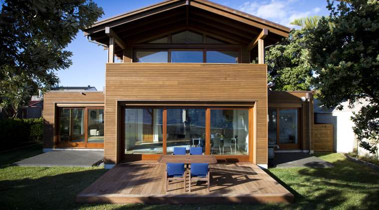 In this seaside house by Novak+Middleton, sliding doors architecture, cottage, elevation, estate, facade, home, house, property, real estate, residential area, siding, villa, window, black