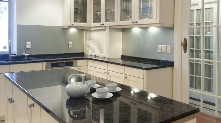 Finishes on the cabinet glass door fronts in cabinetry, countertop, cuisine classique, floor, flooring, hardwood, interior design, kitchen, real estate, room, wood flooring, gray