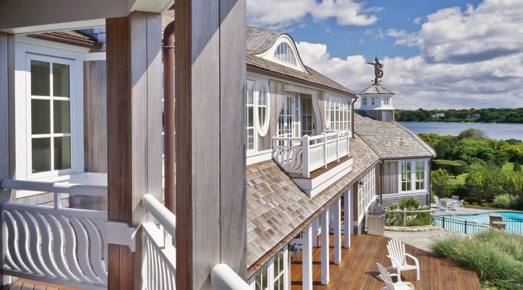 The generous decking, French doors and uniform white apartment, balcony, cottage, deck, estate, home, house, outdoor structure, porch, property, real estate, residential area, siding, window, wood, gray