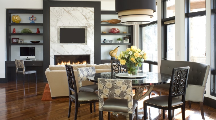 Black frames and polished wood floors provide a dining room, furniture, home, interior design, living room, room, table, white