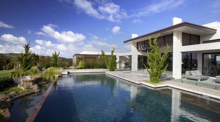 Designed by Robin Shafer, this Japanese-inspired landscape relates backyard, estate, home, house, mansion, property, real estate, residential area, resort, swimming pool, villa, blue