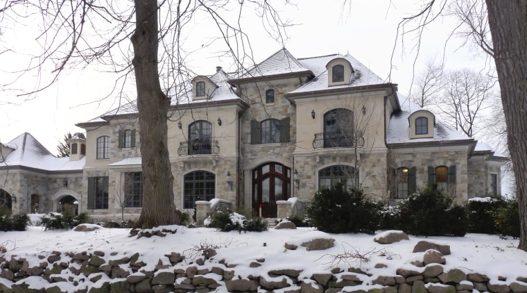 This home looks the part in a winter building, estate, facade, historic house, home, house, manor house, mansion, neighbourhood, property, real estate, residential area, snow, tree, window, winter, white, black