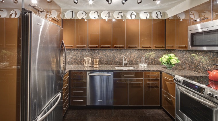 A row of decorative plates enliven the top cabinetry, ceiling, countertop, cuisine classique, interior design, kitchen, real estate, room, under cabinet lighting, brown, gray, black