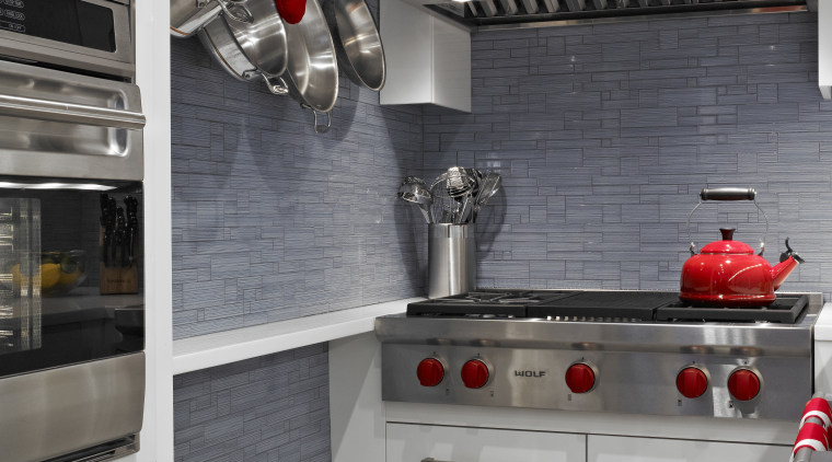Reflective gray-blue glass mosaics line the walls of cabinetry, countertop, home appliance, interior design, kitchen, kitchen appliance, kitchen stove, major appliance, room, gray