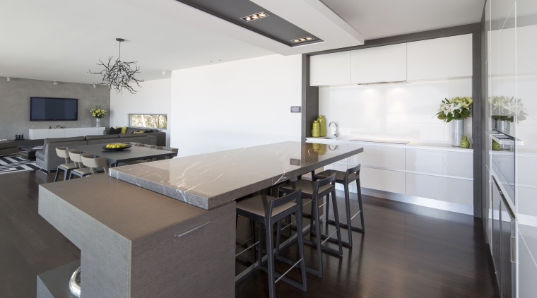 A large, rectangular bulkhead mimics the shape of countertop, floor, interior design, kitchen, real estate, white, gray