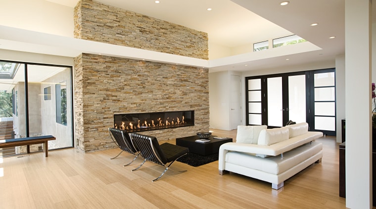 the natural stone wall appears to slice through ceiling, floor, flooring, hardwood, interior design, laminate flooring, living room, real estate, room, wall, wood, wood flooring, white