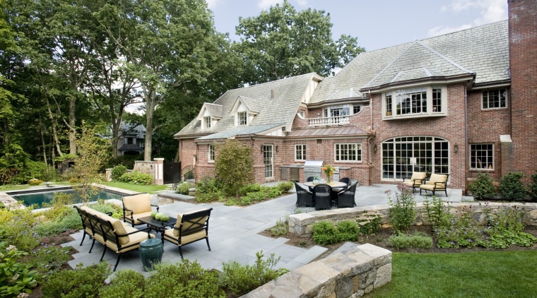 An extensive remodeling project has transformed this 1920s backyard, cottage, courtyard, estate, farmhouse, garden, home, house, landscape, landscaping, outdoor structure, property, real estate, yard