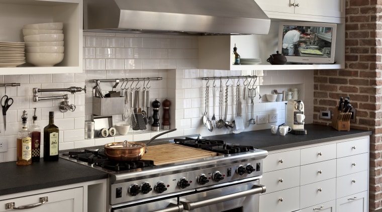 Designed for the serious cook, this kitchen features cabinetry, countertop, cuisine classique, home appliance, interior design, kitchen, kitchen appliance, kitchen stove, gray