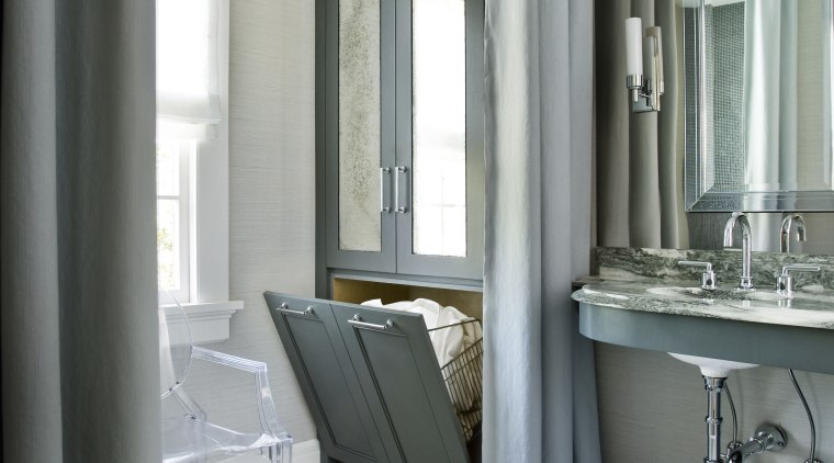 A tall hutch with antiqued mirror doors is bathroom, bathroom accessory, floor, flooring, home, interior design, room, window, gray