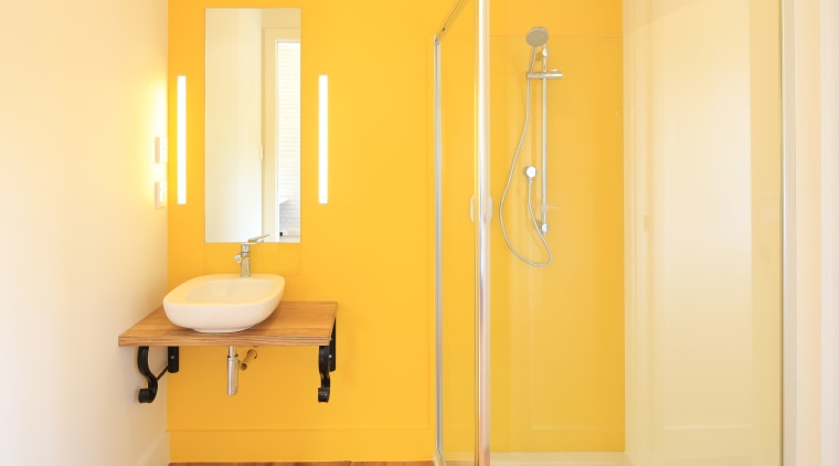 Oversized cavity sliders and lively yellow wall paint bathroom, floor, interior design, plumbing fixture, product design, room, wall, yellow, orange