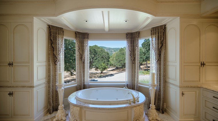 An MTI Whirlpools tub sits in front of bathroom, bathtub, estate, home, interior design, real estate, room, window, brown, gray