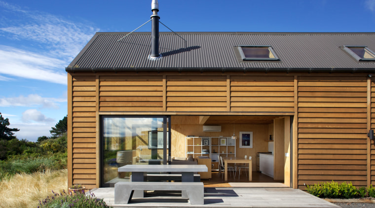 The living area of this simple beach house cottage, elevation, facade, home, house, real estate, roof, siding