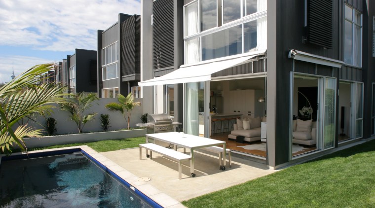 A modern townhouse custom built and designed by apartment, architecture, condominium, elevation, estate, home, house, property, real estate, residential area, swimming pool, villa, window, black