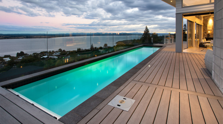 This modern lap pool forms the centrepiece of deck, estate, leisure, property, real estate, roof, sky, swimming pool, water, gray