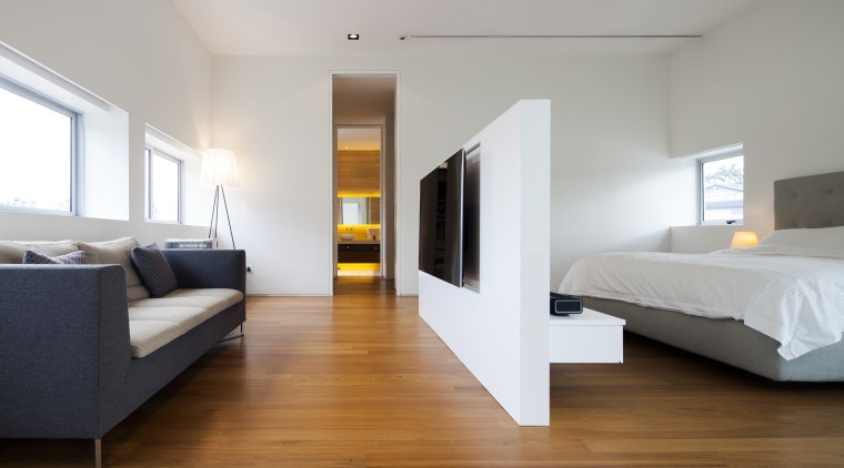 A freestanding wall divides this master suite and architecture, bed, bed frame, bedroom, ceiling, floor, flooring, furniture, hardwood, interior design, laminate flooring, real estate, room, suite, wood, wood flooring, gray