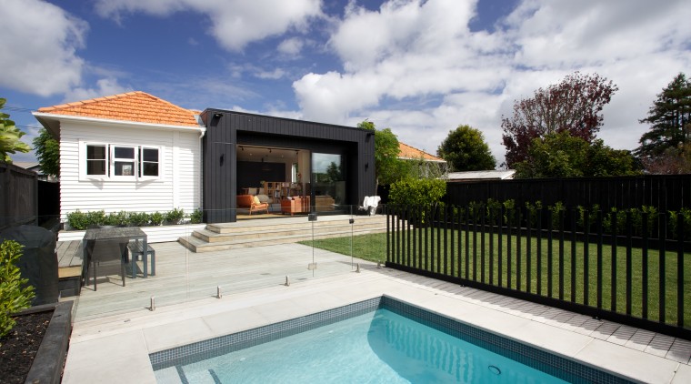 Contemporary black box addition to older home the backyard, estate, facade, home, house, outdoor structure, property, real estate, residential area, swimming pool, villa, gray