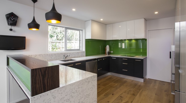 The green glass splashback and Silestone benchtops form cabinetry, countertop, floor, interior design, kitchen, property, real estate, room, gray