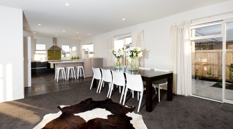 This new steel-framed show home in Hamill Rd, dining room, floor, flooring, home, house, interior design, living room, property, real estate, room, table, white