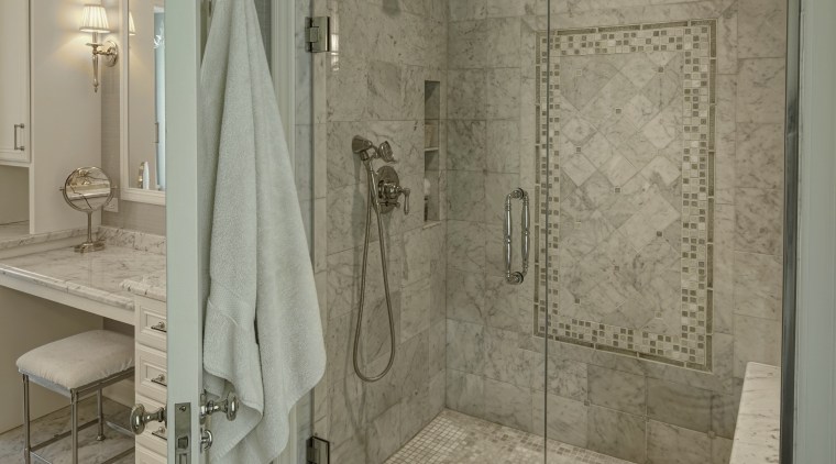In this remodel by architect Scott Javore a bathroom, ceiling, floor, flooring, home, interior design, plumbing fixture, room, tile, wall, gray, brown