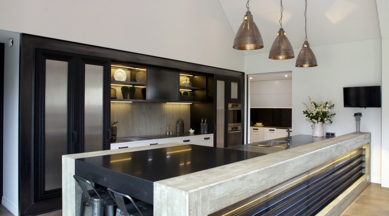 Solid concrete frames the 5.4m-long island in this countertop, floor, furniture, interior design, kitchen, table, gray