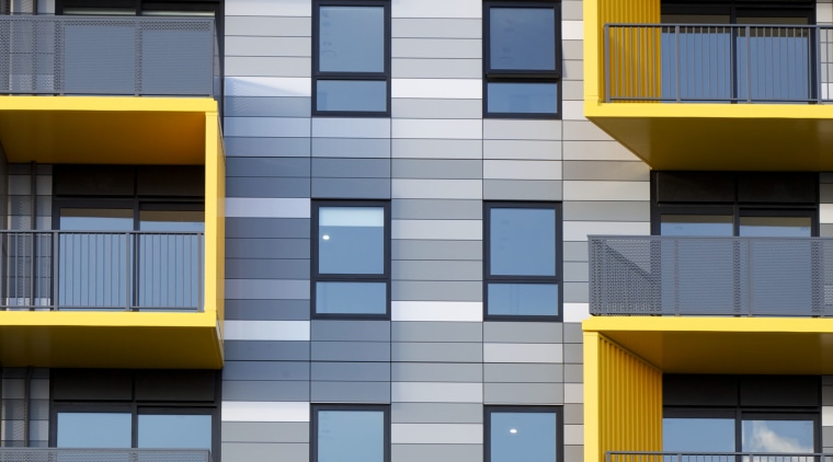 A close-up view of the colourful Alucobond cladding apartment, architecture, building, commercial building, condominium, daytime, elevation, facade, house, line, mixed use, residential area, symmetry, window, yellow, gray