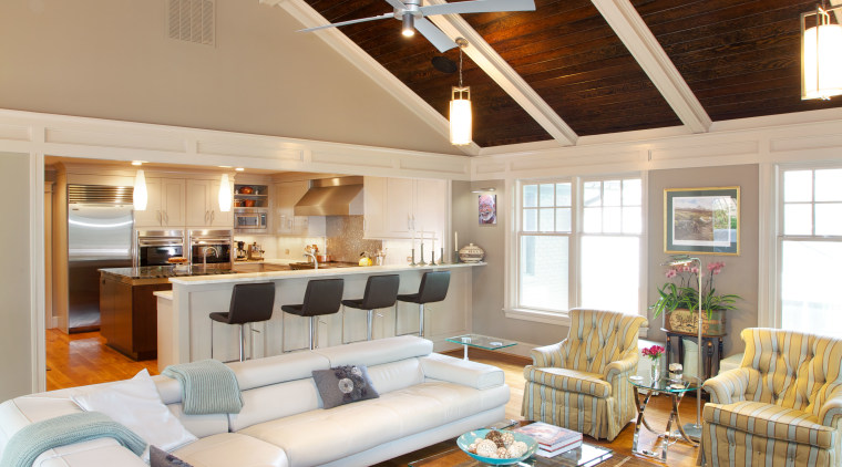 This open-plan family room and kitchen are part beam, ceiling, daylighting, floor, flooring, hardwood, home, interior design, living room, loft, real estate, room, wood, wood flooring, white, brown